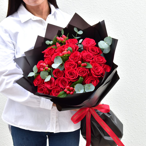 premium red roses, eucalyptus bouquet with black wrapping