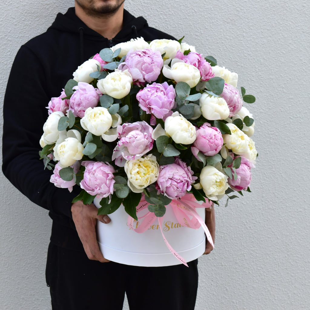 premium pink and white peonies in a white round hatbox with touch of eucalyptus - peony delivery dubai