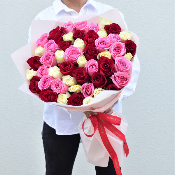 premium red, pink and white roses bouquet with white wrapping