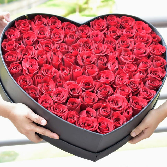 red roses in heart box